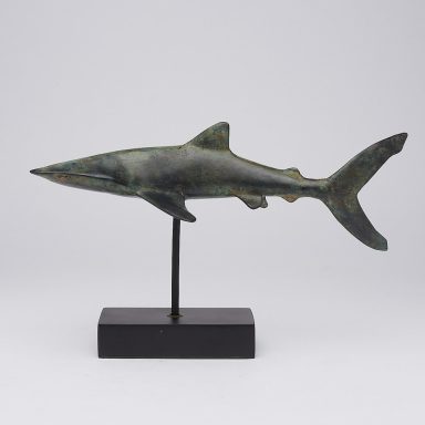 Sculptur eines Haifischs auf einem schwarzen Sockel.