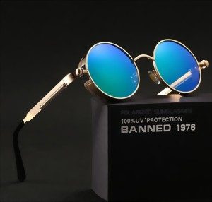 Runde Sonnenbrille mit goldenem Rahmen und blauer Spiegelung, neben einer Box mit Aufschrift.